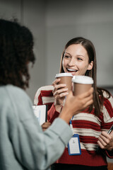 colleagues clinking cups of coffee in office.