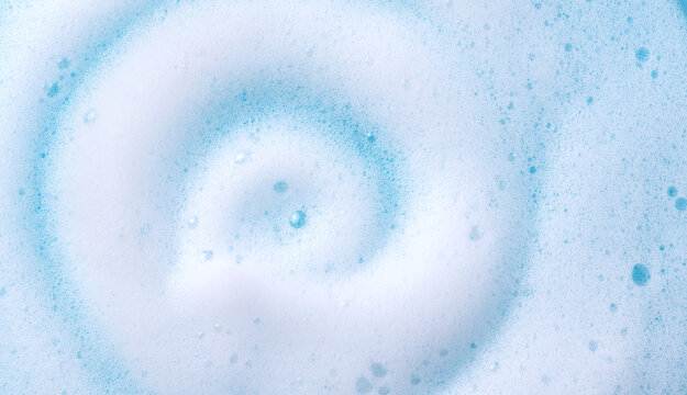 Foam swirl background. Liquid soap bubbles, Froth bubbles backdrop. Soap foam white backdrop. Soap sud macro structure close-up. Clean, cleaning, washing, laundry. Top view