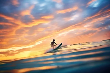 Poster silhouette of a surfer riding a wave during sunset © primopiano