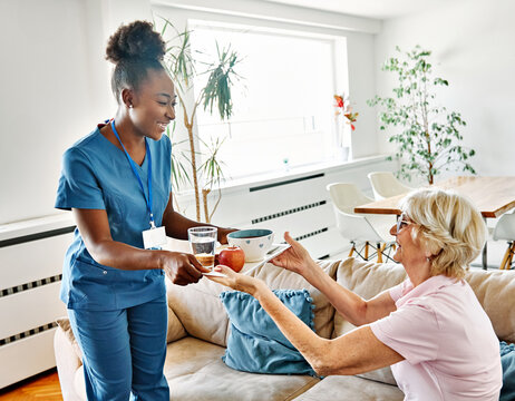 nurse senior woman home care patient elderly lunch caregiver meal food hospital eating eat recovery health retirement assistance nursing old support reaching out