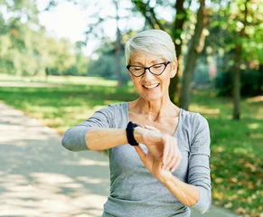 Foto op Plexiglas senior fitness woman jogging sport exercise watch pulse technology smart smartwatch athlete wrist healthy performance active tracker app device © Lumos sp