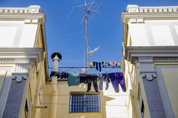Colorful clothes hanging on some ropes with clothespins
