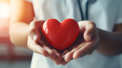 Close up hand of Doctor's hand holding a red heart shape in a hospital. love, donor, world heart day, health, insurance concept.