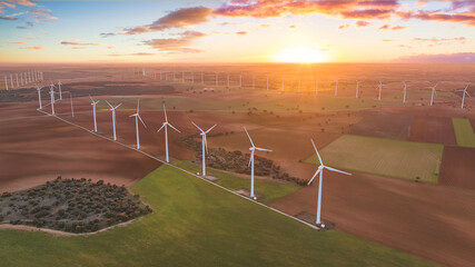 Renewable energy with wind turbines in a farm at sunset. Aerial view of wind turbines in eolic park. Spain