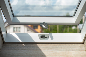 open attic window, view of the sky and houses. High quality photo © Irina