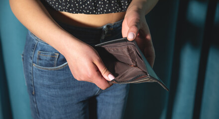 Young woman showing empty wallet. Crisis