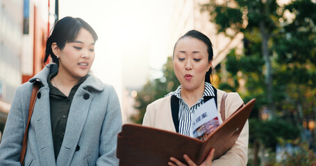 Talking, walking and Japanese women with a document in the city for business or teamwork on a project. Morning, smile and hr manager in Japan reading a report with an employee for recruitment
