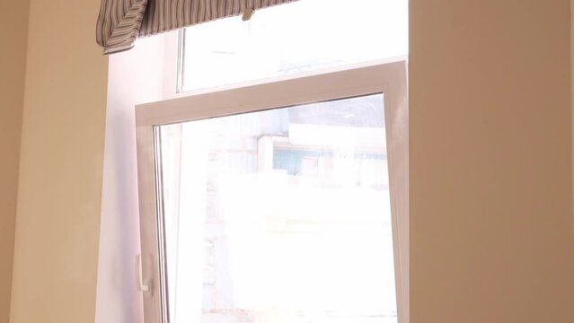 Fresh air intake. Window sash for winter ventilation. A cold, frosty air stream intensely penetrates the room. Plastic windows with double glazing. 