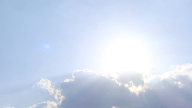 Sun light ray n lens flare or bokeh sunlight shining through dark rain storm cloud or cumulus cloudscap on bright blue sky in tropical summer daylight sunshine day, 4k slow n stop motion TimeLapse