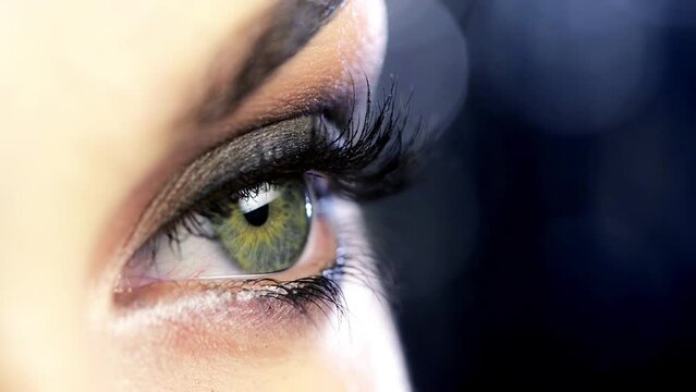 Closeup, smokey eye and woman with cosmetics, aesthetic and luxury on dark studio background. Person, girl and model with eyelashes and grooming routine with self care, makeup and mascara with beauty