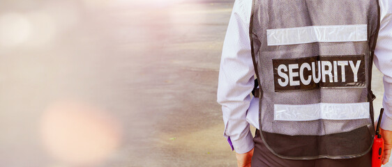 Back view Senior man security guard takes care security for various companies and stores or...