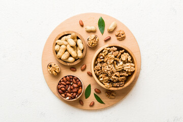 Walnut kernel halves, in a wooden bowl. Close-up, from above on colored background. Healthy eating Walnut concept. Super foods with copy space