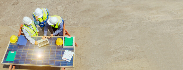 Top view team male engineers discuss energy engineering business issues on solar panels save money...