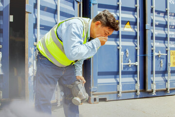 Male worker was about inspect the container holding chemical ammonia protection mask felt stink and felt dizzy because inhaled toxic fumes chemicals that were toxic to the respiratory 