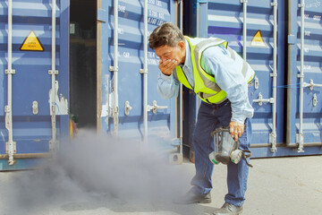 Male worker was about inspect the container holding chemical ammonia protection mask felt stink and felt dizzy because inhaled toxic fumes chemicals that were toxic to the respiratory 