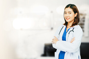 Female volunteer doctor physician surgeon in portrait in white uniform with gentle medical stethoscope sitting in a chair in the office relaxing smiling at the camera friendly to everyone.