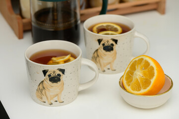 black tea with lemon in cups with a drawn pug 4
