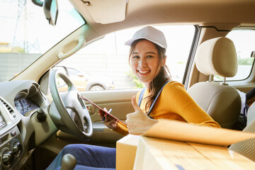 Beautiful asian female parcel delivery service driver driver pickup transports customer parcel box...