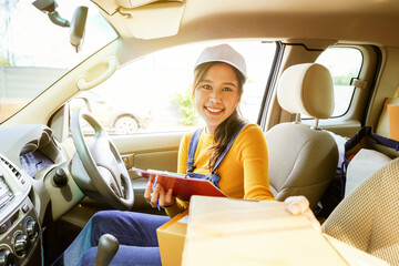 Beautiful asian female parcel delivery service driver driver pickup transports customer parcel box...