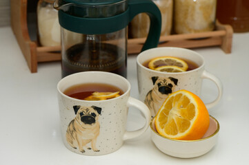 black tea with lemon in cups with a drawn pug 6