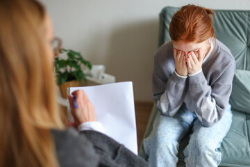 A portrait of female patient consulting with a female doctor, the patient is crying