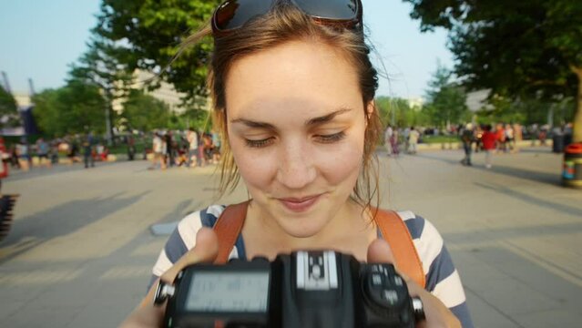 Face, woman and camera for photographer in the city, travel and summer tourism in Italy. Portrait, lens or happy girl taking pictures in urban street for hobby, adventure and vacation trip by outdoor