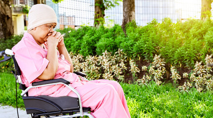 Elderly asian woman wearing  headscarf sitting wheelchair worried, mentally unhappy stressed by the...