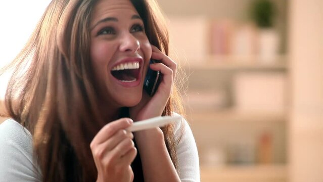 Woman, phone call and pregnancy test for happy good news communication, celebration or ivf. Female person, announcement and excited for healthy results for fertility stick for care, surprise or smile