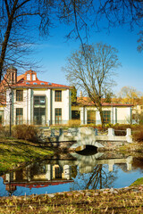 Obraz premium Bernardinu Park in Vilnius during spring with calm pond and fresh greenery