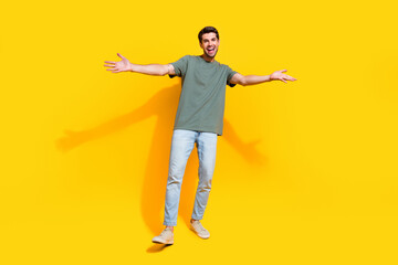 Full length photo of cheerful positive man dressed khaki t-shirt open arms missing you isolated...