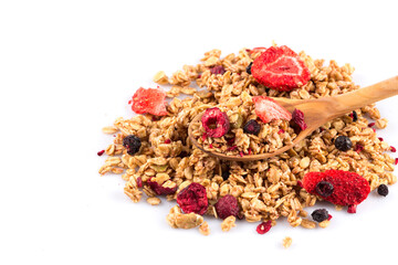 Muesli oat cereals close up background with dry fruits in wooden spoon
