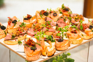 Sandwiches with meat, fish and microgreens.