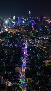 Night timelapse of downtown Ho Chi Minh City and the illuminated Bui Vien party street, Vietnam.