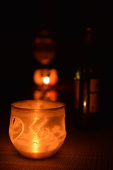Small candle and bottle of wine