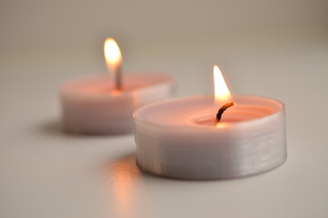 Two small candle on a white background