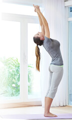 Woman, stretching spine and yoga for health, wellness and warm up in home with holistic fitness or...