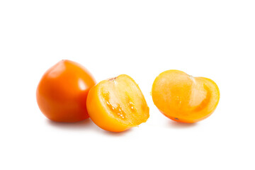 Whole and half of yellow tomato isolated on white background.