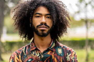 portrait of cool young african american adult with afro hair and piercing, looking at camera seriously - obrazy, fototapety, plakaty