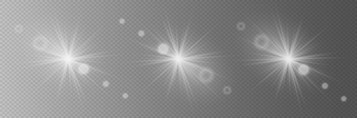 Collection of realistic white light flashes. The effect of magical stars with sun rays. Flashing lights on a transparent background.