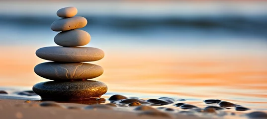 Fototapeten Tranquil zen stones resting on smooth sand beach in serene natural setting © Aliaksandra
