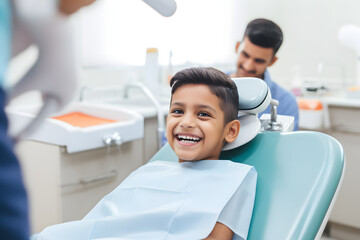 A smiling young indian boy in a dental chair. Examination by a dentist