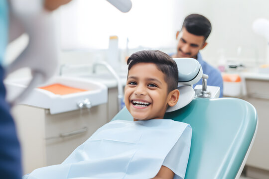 A smiling young indian boy in a dental chair. Examination by a dentist