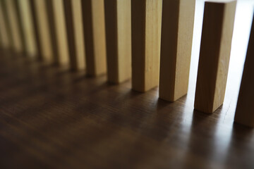 Closeup thick domino wood block in a row stop the falling, be stable in crisis, business solution concept
