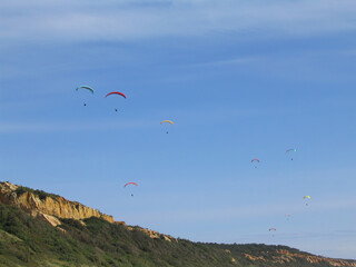 Paragliding in the Fonte da Telha beach, a popular location for Paragliders who advantage of the air currents generated by the sea and the cliffs called Arriba Fossil. Fonte da Telha, Almada, Portugal