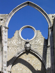 Ruins of the Gothic Church of the Carmo Convent aka Our Lady of Mount Carmel. Roofless nave and arches stand as a testimony to the 1755 earthquake that destroyed Lisbon. Lisbon, Portugal - obrazy, fototapety, plakaty