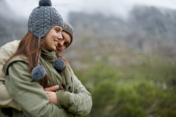 Couple, hug and smile on hiking vacation in outdoors, love and bonding in relationship for connection. People, embrace and travel for exploring adventure, romance and security in marriage on mountain