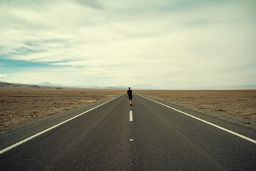 A man walking forward on the road - obrazy, fototapety, plakaty