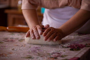 Obraz na płótnie Canvas Cook's hands kneading dough for cakes. Preparing the flour for leavening