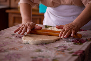 Cook's hands kneading dough for cakes. Preparing the flour for leavening