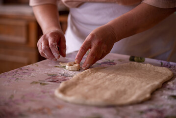 Cook's hands kneading dough for cakes. Preparing the flour for leavening